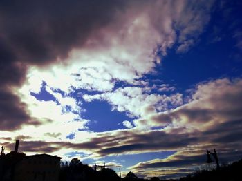 Low angle view of silhouette buildings against sky at sunset