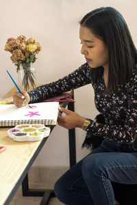 Artist learning new activity at home, during quarantine, painting with watercolor