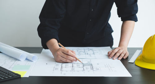 Midsection of businessman working at office