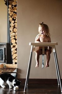 Full length of boy sitting on floor at home