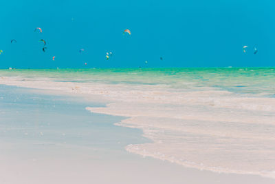 Scenic view of beach against blue sky