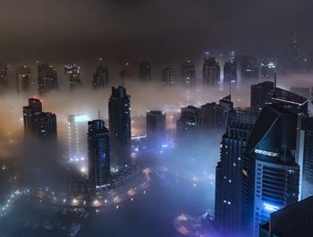 High angle view of illuminated buildings in city at night