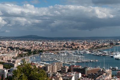 High angle view of buildings and sea against sky