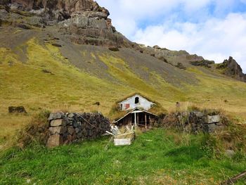Built structure on field against sky