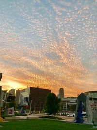 Scenic view of city against sky during sunset