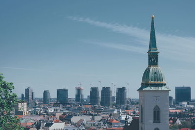 Buildings in city against sky