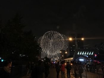 Low angle view of fireworks at night