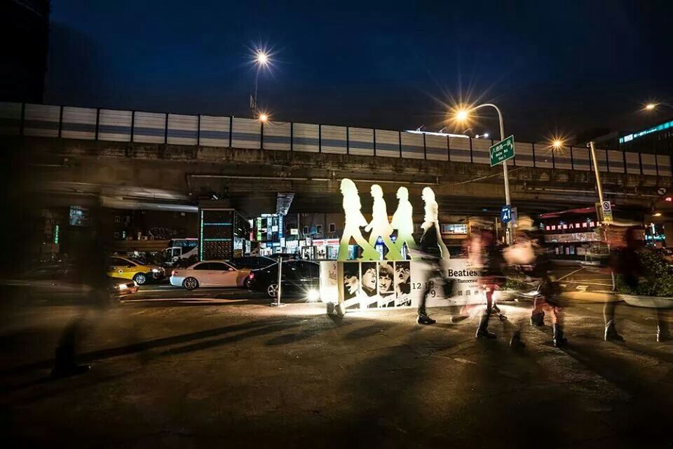 illuminated, night, street light, transportation, street, text, lighting equipment, built structure, western script, city, building exterior, architecture, road, information sign, communication, sign, mode of transport, road sign, city life, land vehicle