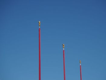 Low angle view of communications tower against clear blue sky