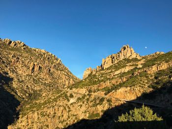 Scenic view of mountains against clear blue sky