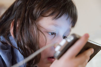 Close-up of girl using mobile phone