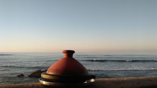 Scenic view of sea against clear sky during sunset