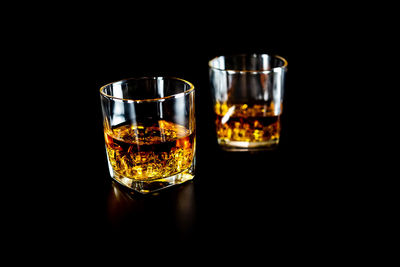 Close-up of wine glass against black background