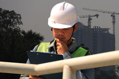 Man holding camera at construction site