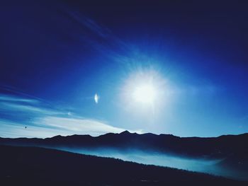 Scenic view of silhouette mountain against blue sky