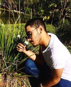 Young man sitting on grass