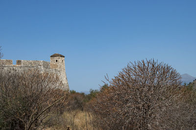 Low angle view of historic building against clear blue sky