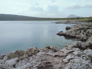 Scenic view of sea and mountains against sky