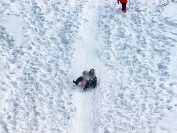 High angle view of woman skiing on snow covered field