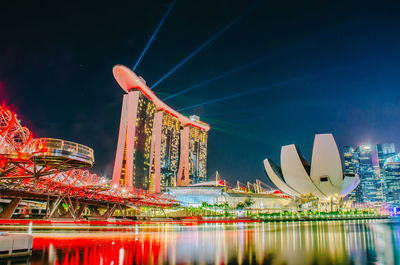 Digital composite image of illuminated ferris wheel at night