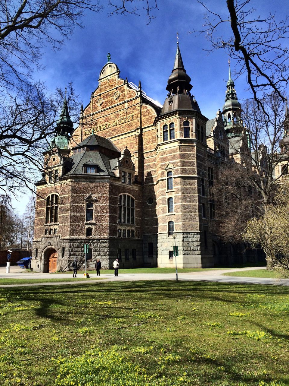 building exterior, architecture, built structure, grass, church, place of worship, tree, facade, religion, lawn, sky, spirituality, cathedral, history, travel destinations, dome, famous place, incidental people