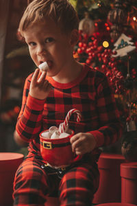 Close-up of cute girl blowing christmas tree