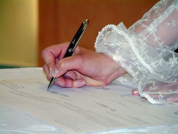 Close-up of woman hand holding paper on table