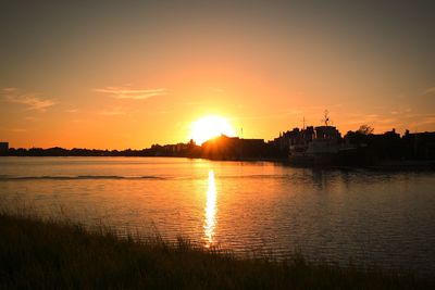 Scenic view of lake against romantic sky at sunset