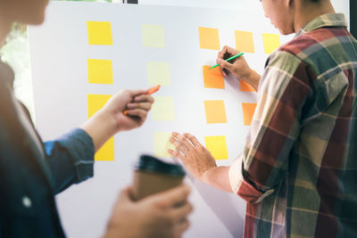 Midsection of young businessmen working in office