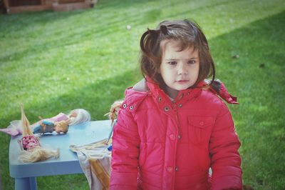 Portrait of girl playing on grassy field