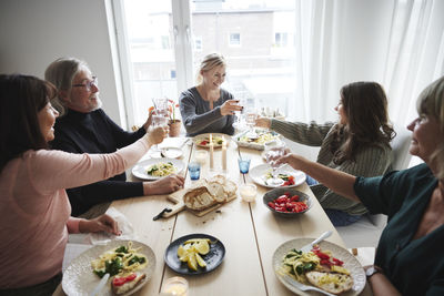 Family raising toast during dinner