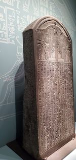 Close-up of open book on table against wall