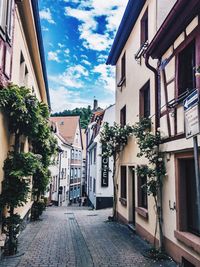 Street amidst houses against sky