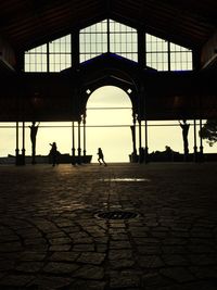 View of people walking through archway