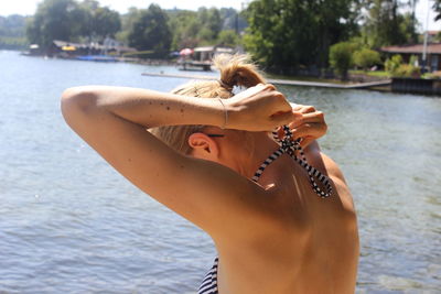 Midsection of young woman in sea