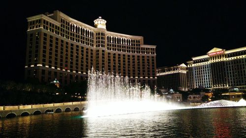 Reflection of buildings in water at night