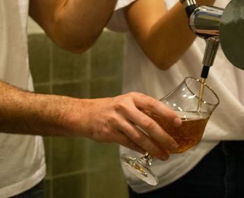 Midsection of man preparing food in glass