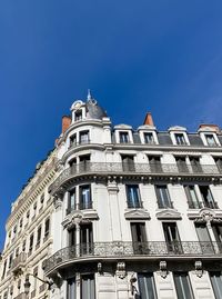 Low angle view of building against blue sky