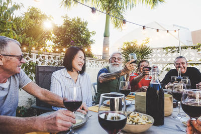 Friends enjoying wine at outdoor restaurant