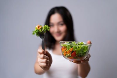 Midsection of woman holding ice cream