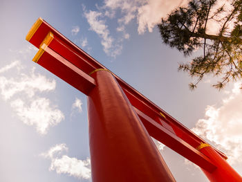 Low angle view of red bell tower against sky