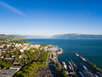 High angle view of city by sea against clear sky