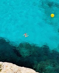 High angle view of people swimming in sea