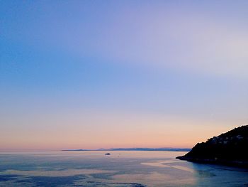 Scenic view of sea against clear sky at sunset