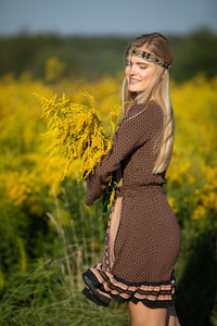 Portrait of young woman standing in forest