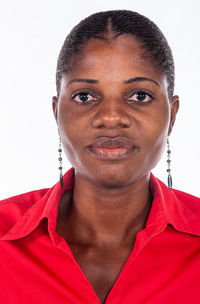 Close-up portrait of young woman against white background