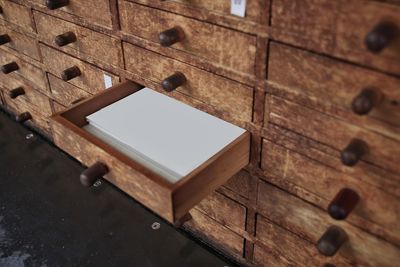 High angle view of documents in open drawer