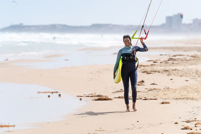 Full length of woman standing on beach