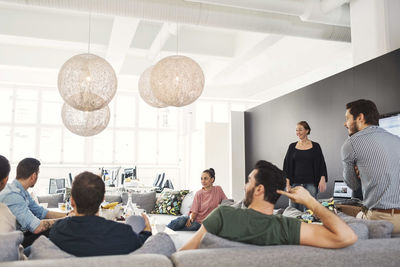 Multi-ethnic business people having discussion in modern office lobby