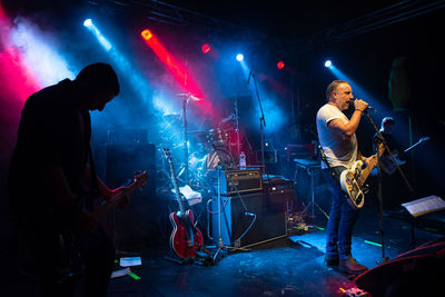 Man playing guitar at music concert